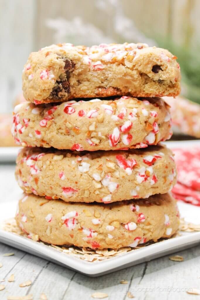 A stack of Christmas Oatmeal Cookies, top cookie with a bite missing