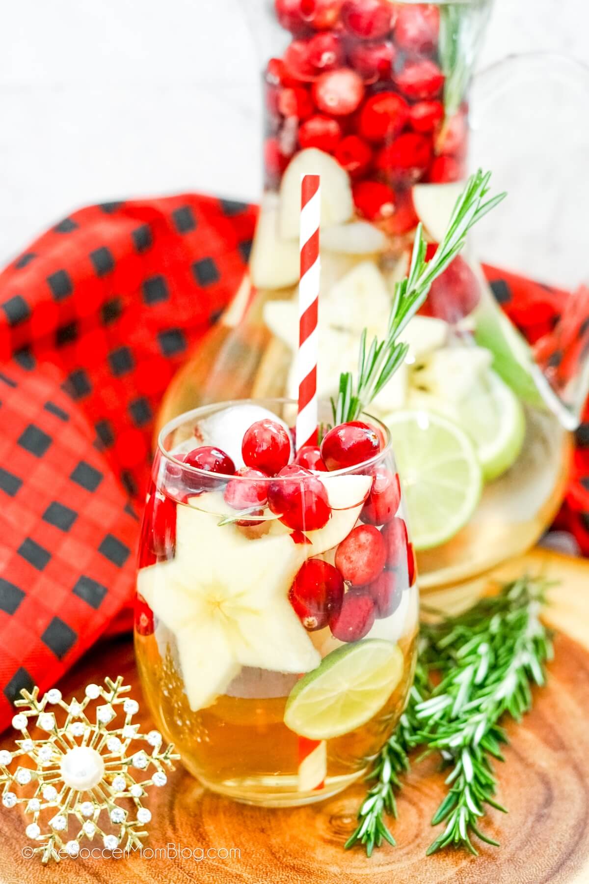 holiday sangria made with sparkling wine, in glass and pitcher
