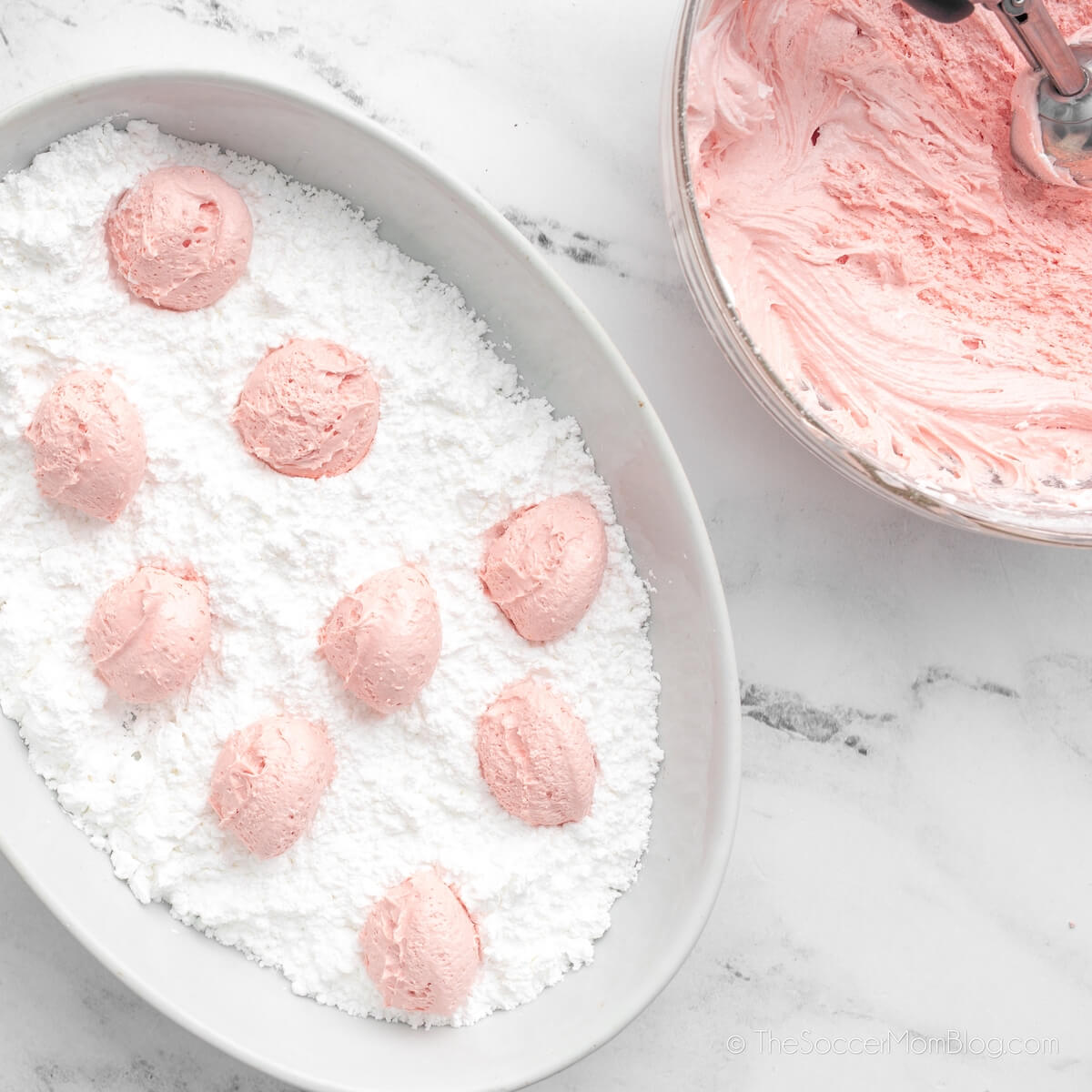 strawberry cool whip cookie dough balls in powdered sugar