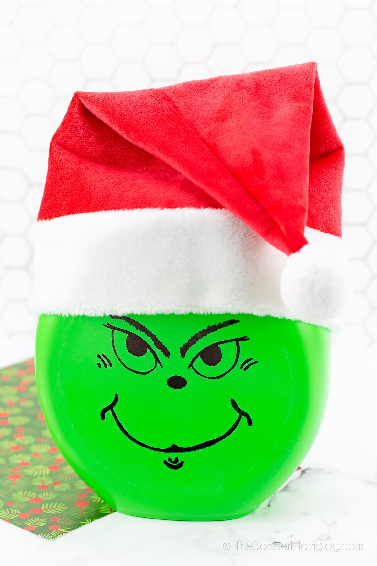 Christmas lantern that looks like the Grinch, made with a Gain pods container