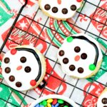 Three Snowman Cookies on a wire rack