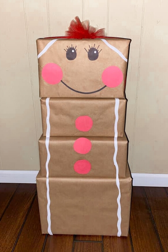 gifts wrapped in brown paper and stacked to look like a gingerbread man