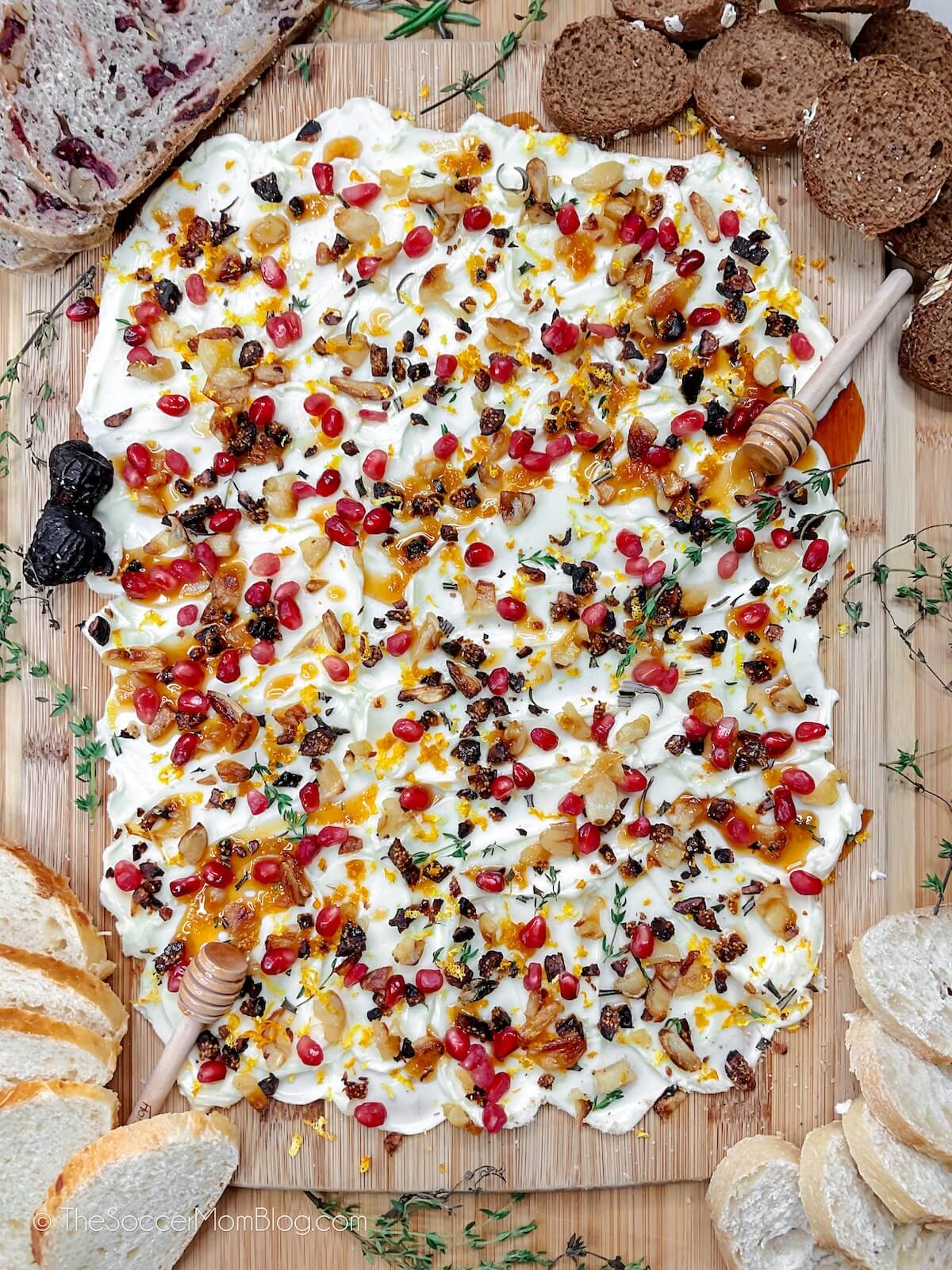 holiday butter board with dried fruit, garlic, and honey