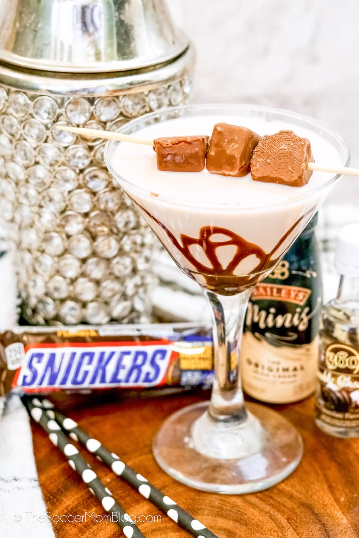 dessert martini with chocolate drizzle and mini Snickers bars on top