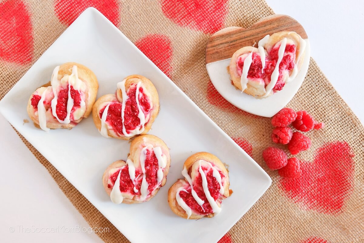 Four Raspberry Crescent Dough Hearts on a white plate