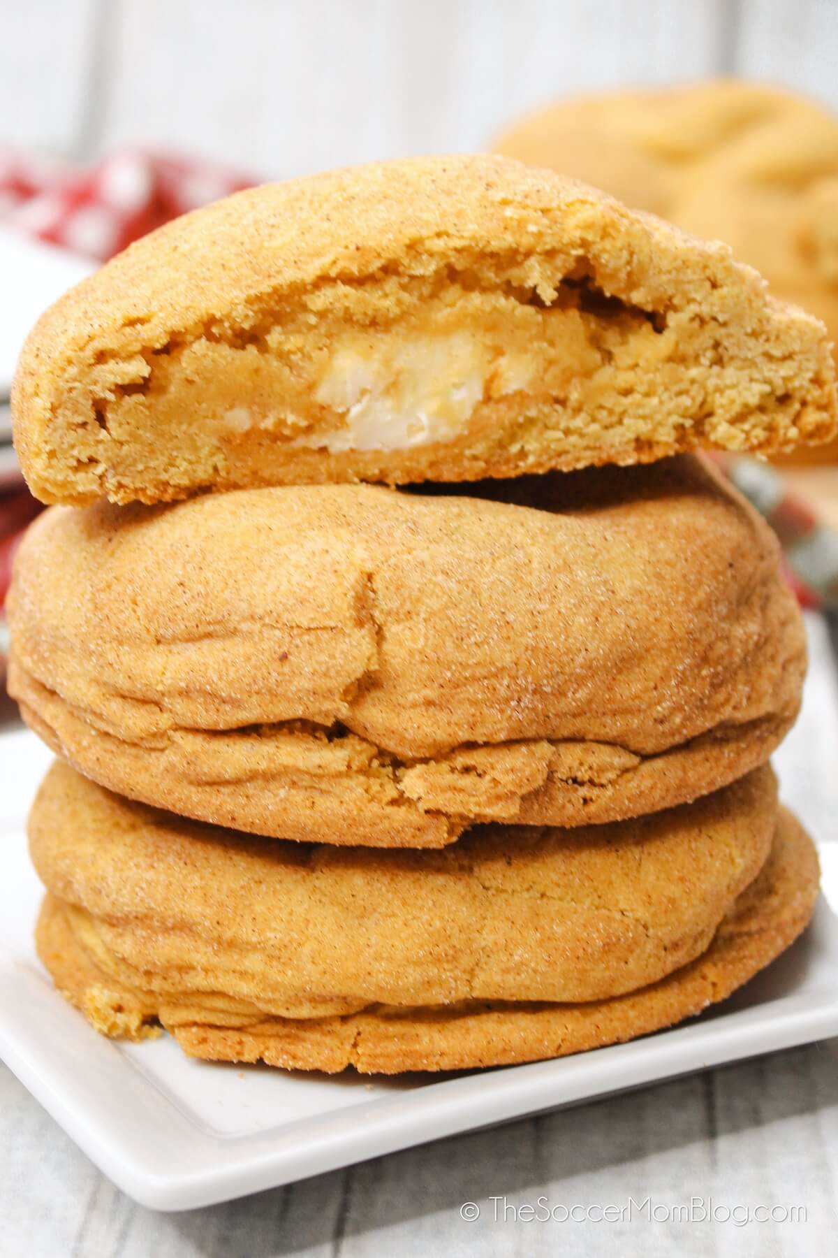 stack of Pumpkin Cheesecake Cookies With one cut in half