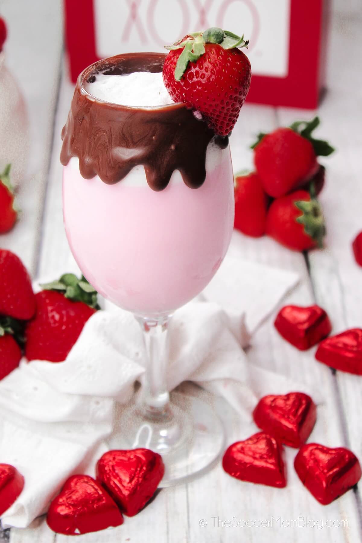 chocolate covered strawberry cocktail in wine glass with chocolate rim