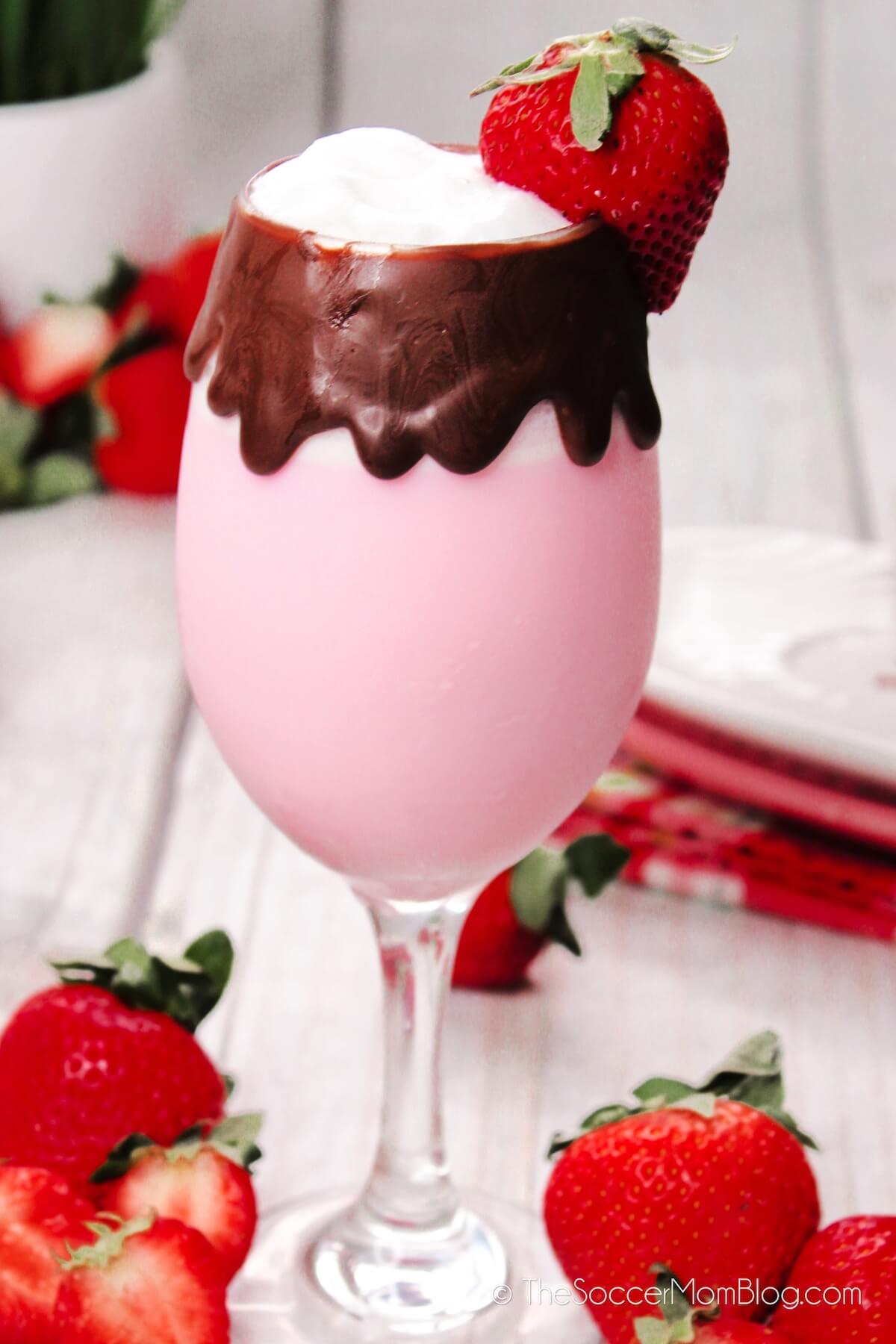 close up of a strawberry martini served in a chocolate coated wine glass