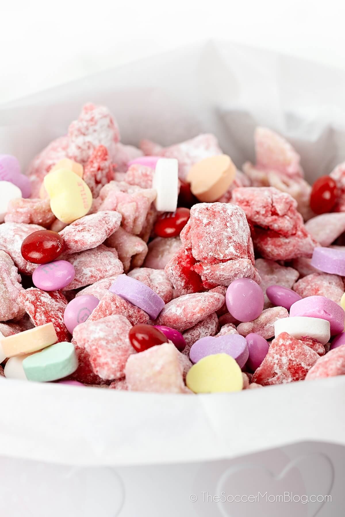 close up of a candy tin filled with Valentine's Puppy Chow snack mix