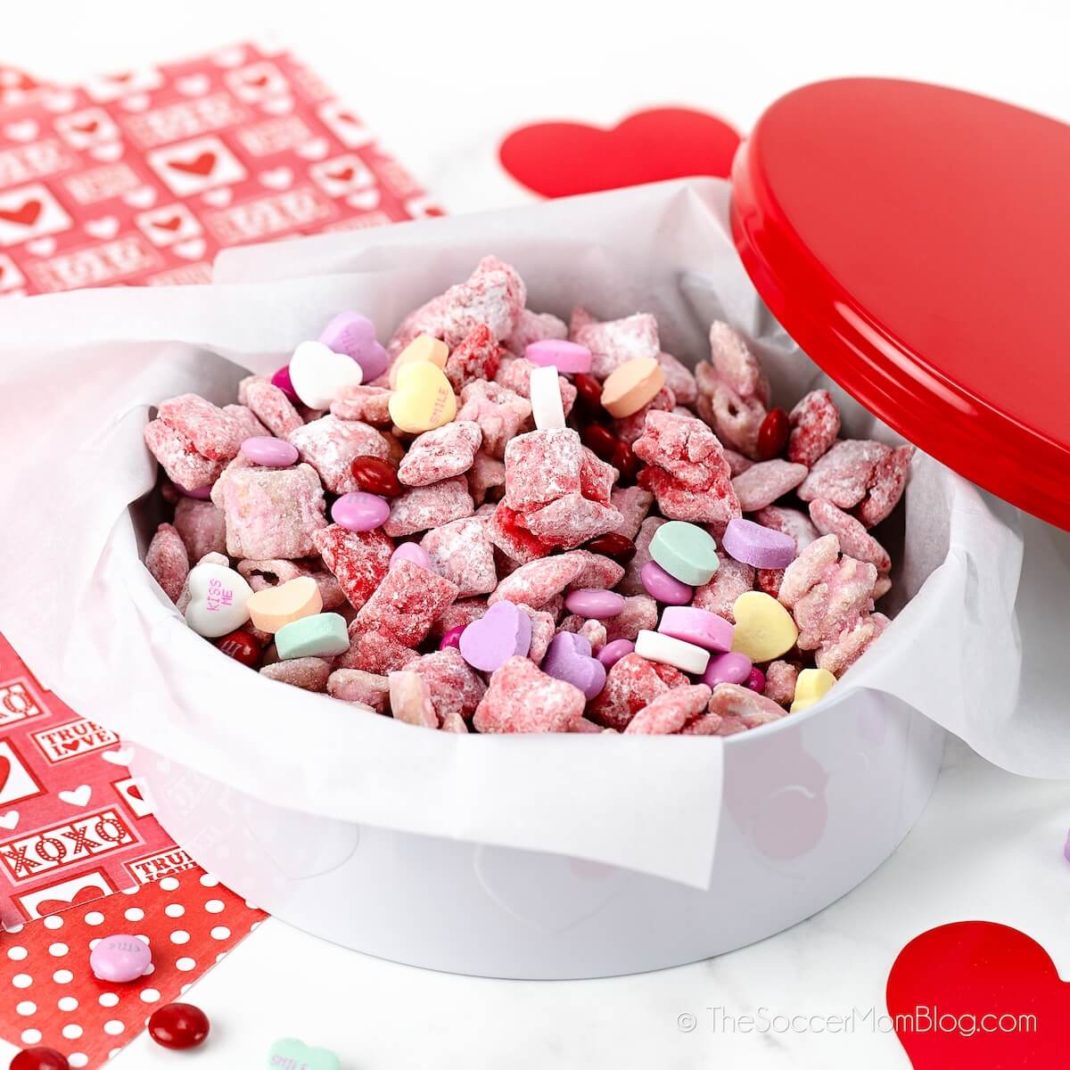 Valentine candy tin filled with red and pink candy coated snack mix
