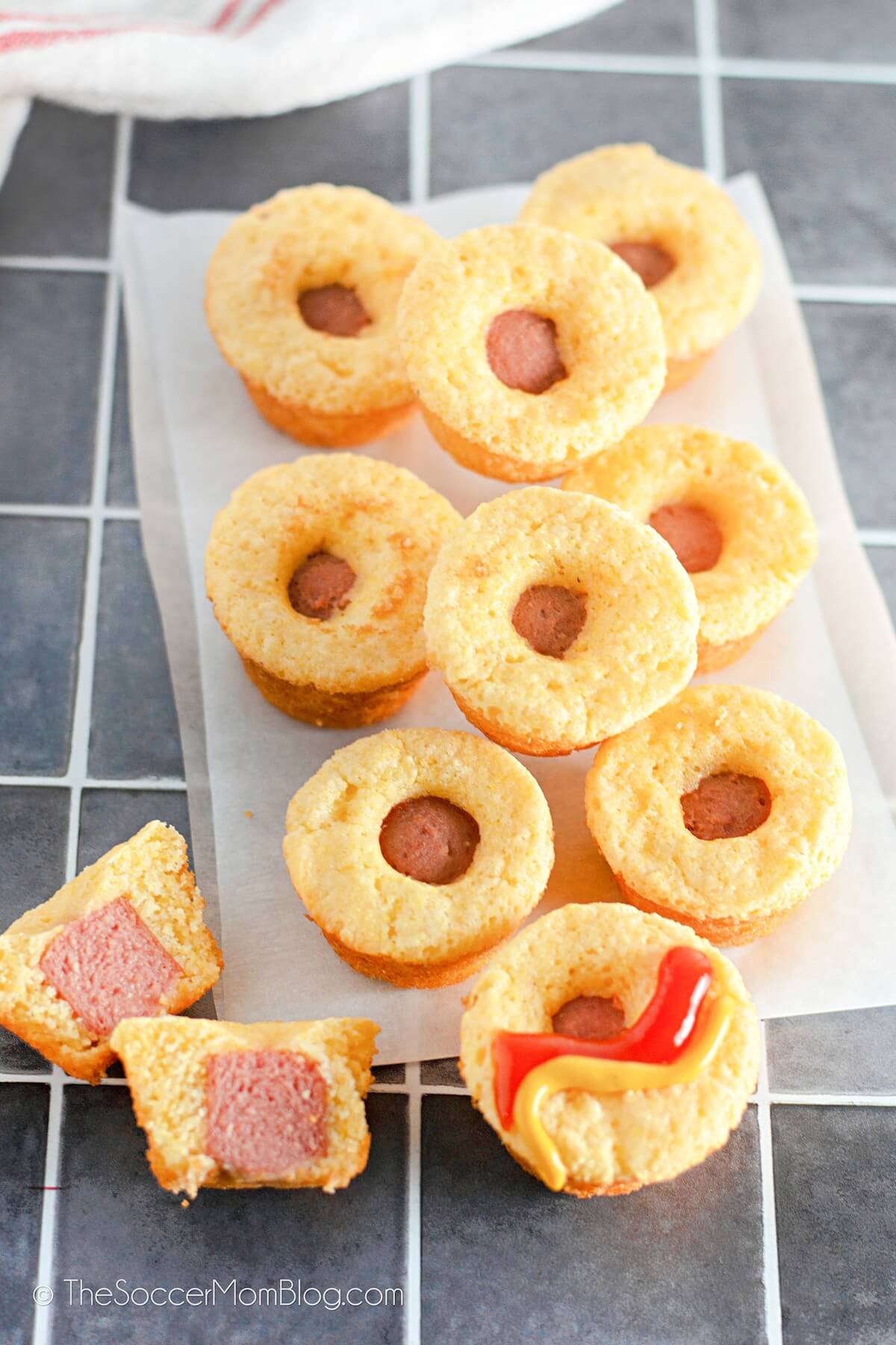 A Pile of Mini Corn Dog Muffins, one cut in half to show detail