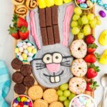 Easter dessert charcuterie board featuring a bunny made from frosting and sweets for dipping