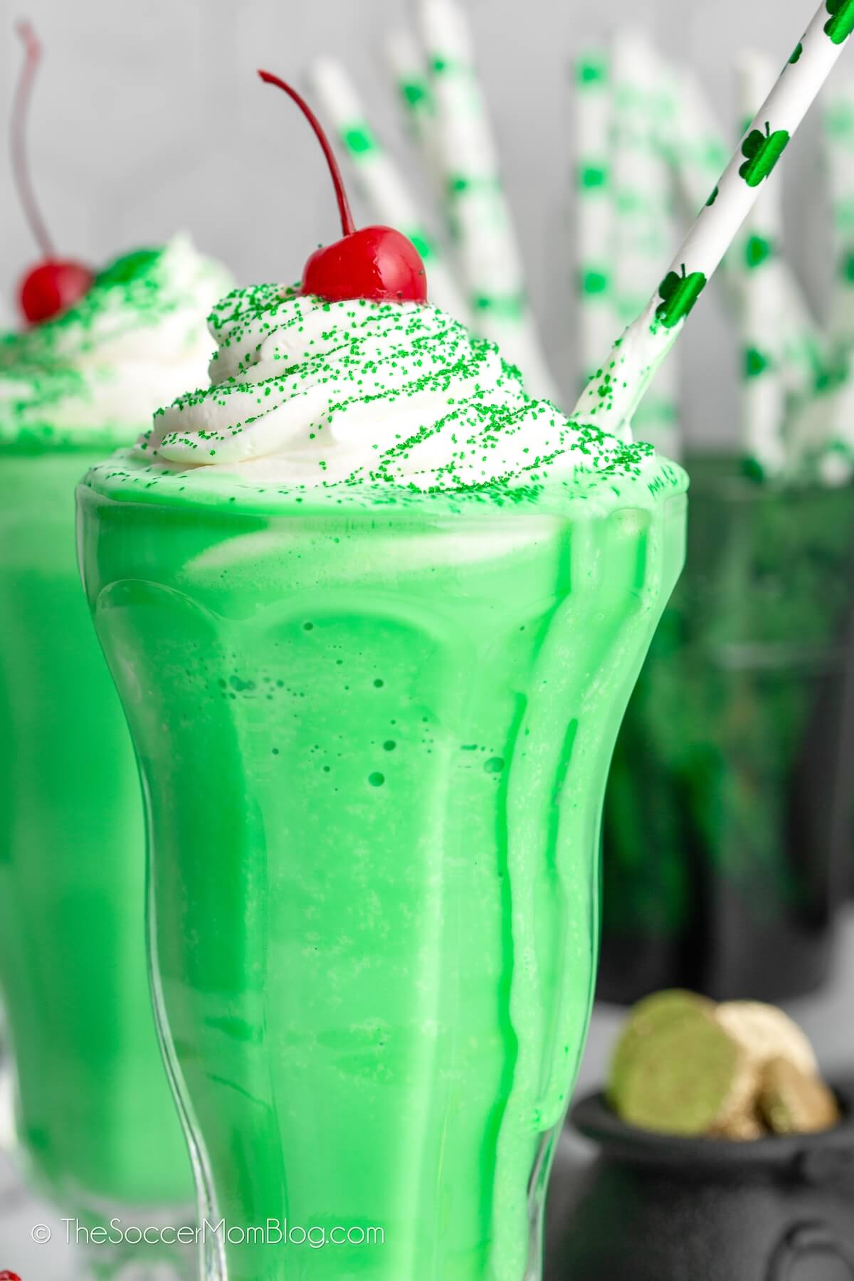 close up of green Shamrock Shake with whipped cream and cherry