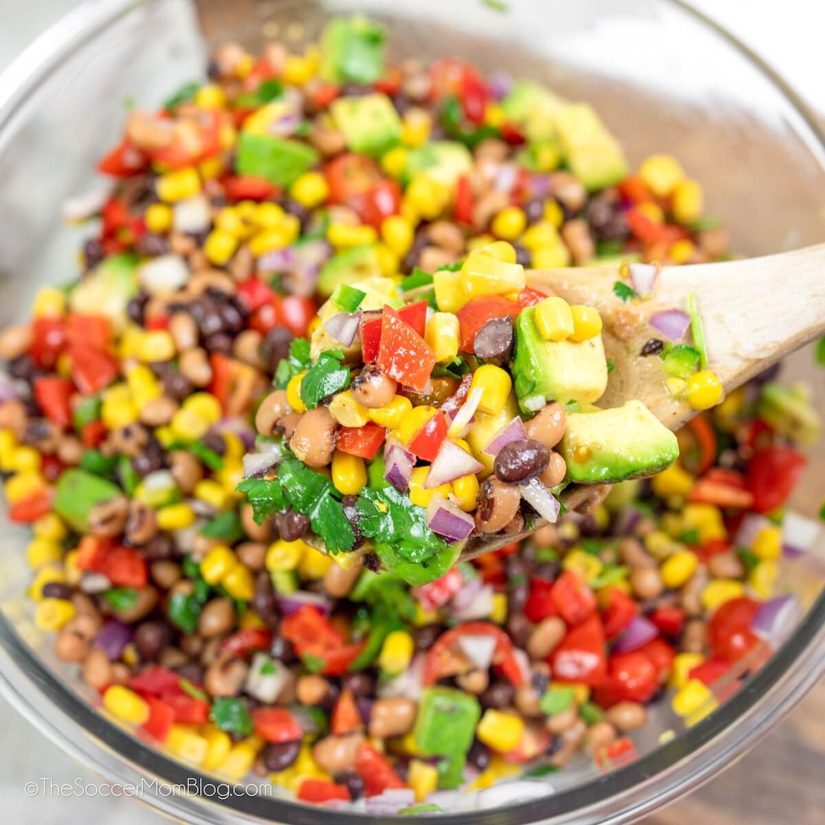 glass bowl with mix of beans, corn, tomatoes, onions, and avocado: aka Cowboy Caviar