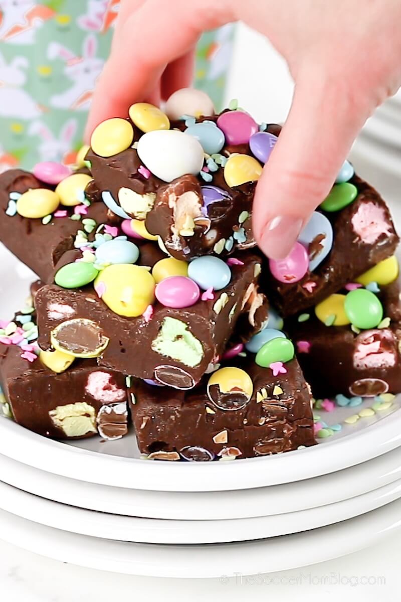 grabbing Easter fudge from plate