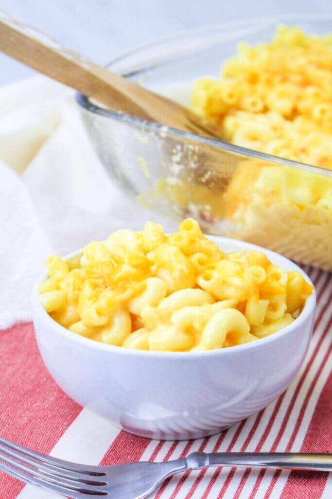 bowl of Mac and Cheese in front of a baking dish