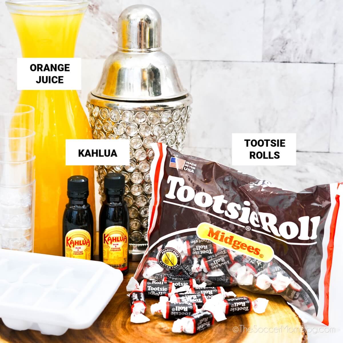 carafe of orange juice, small bottles of Kahlua, and Tootsie Roll candies