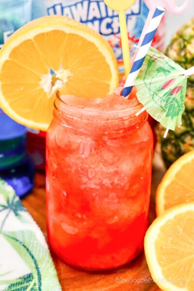 frozen fruit punch cocktail in a mason har, with fresh fruit