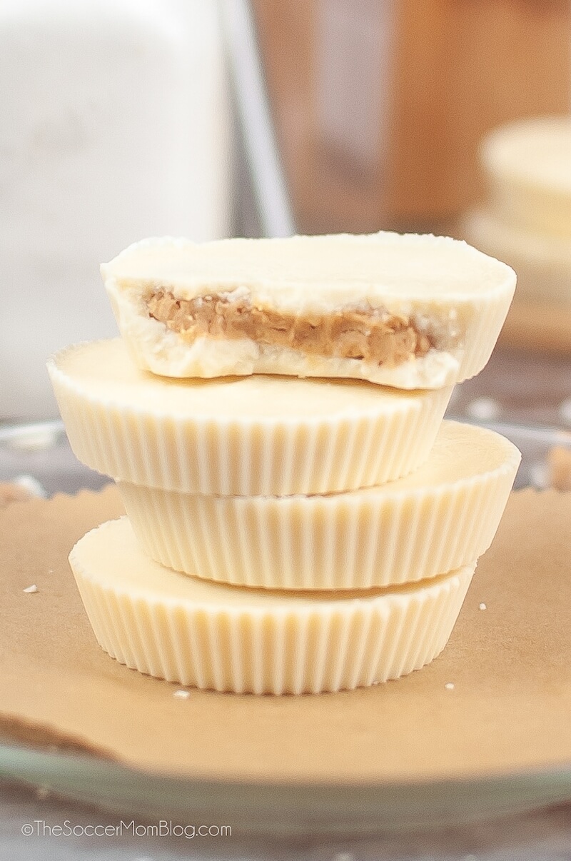 A Stack Four Reese's White Chocolate Peanut Butter Cups, top one cut in half