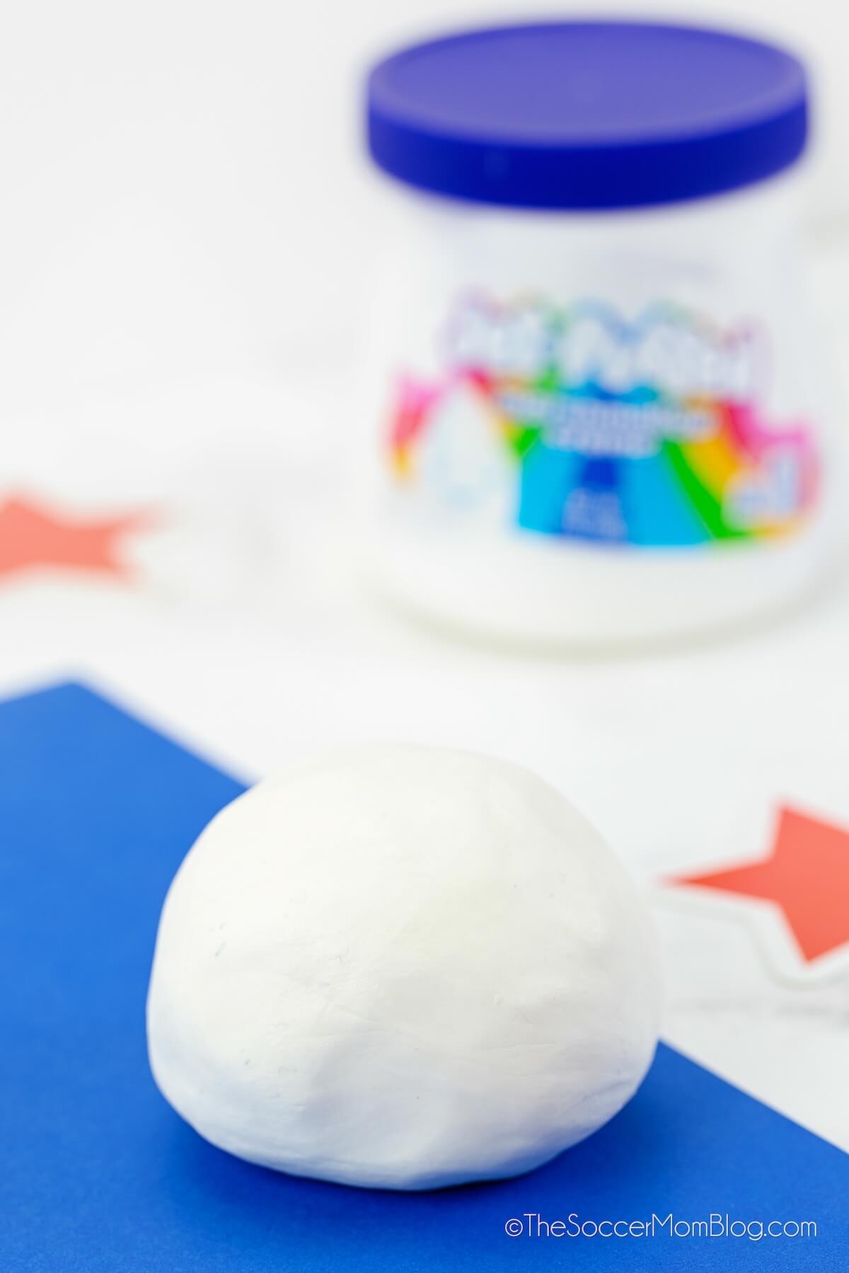 ball of white playdough with container of marshmallow fluff in background