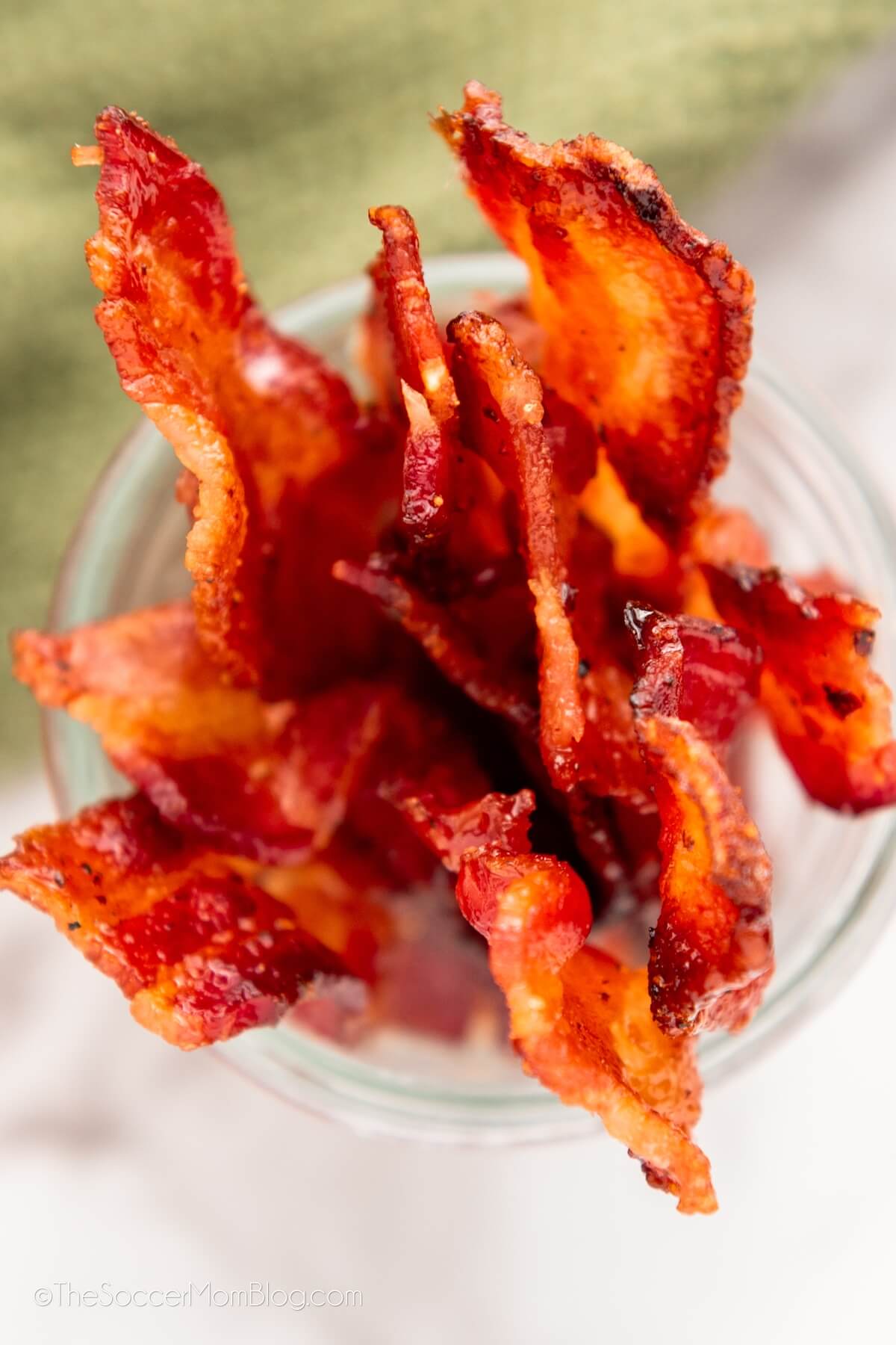 top-down view of crispy candied bacon stored in a mason jar
