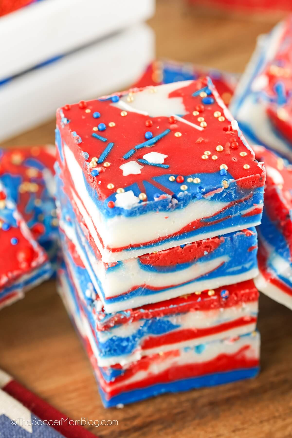 stack of red white and blue fudge on a wooden cutting board