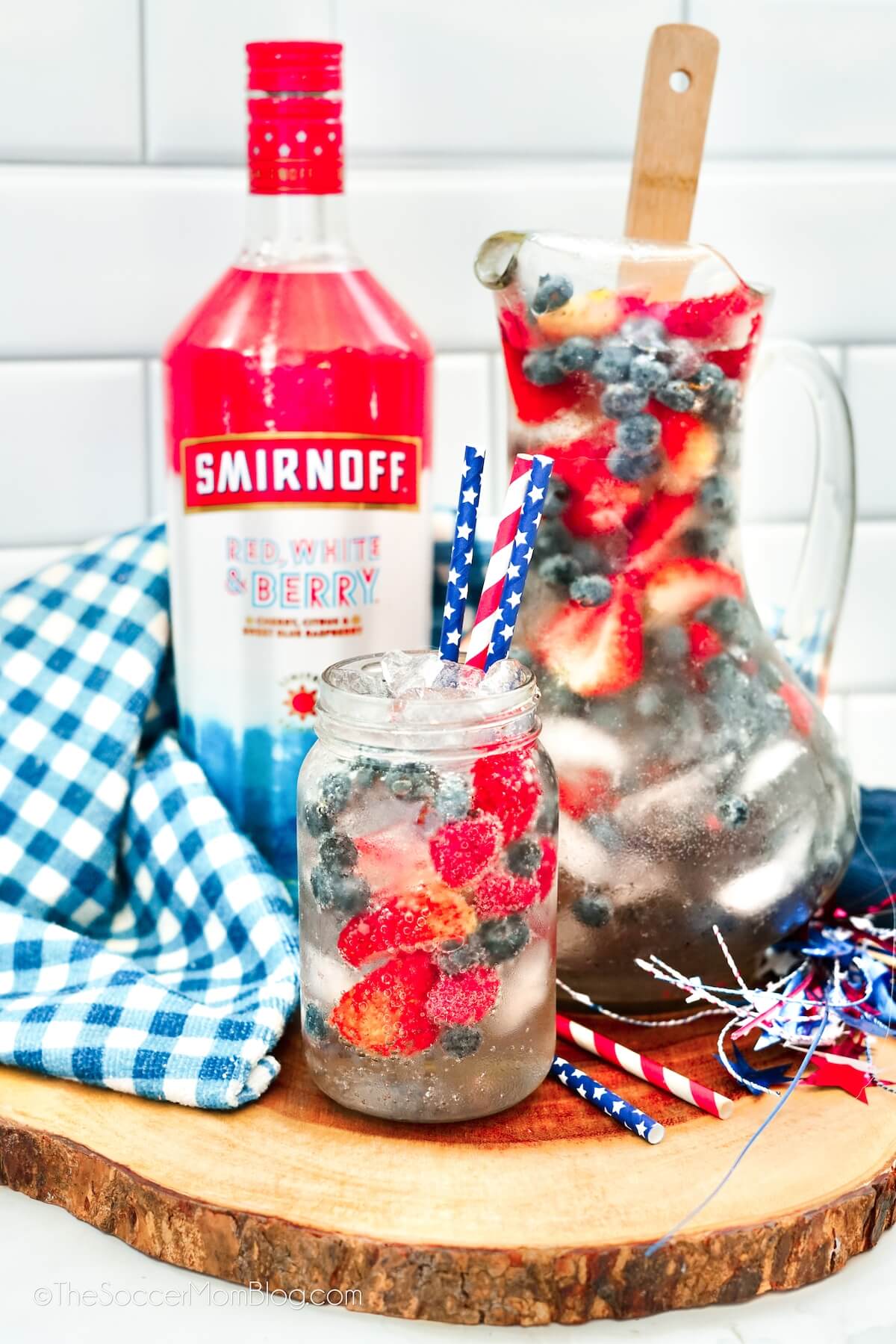 pitcher and mason jar filled with a berry soda punch