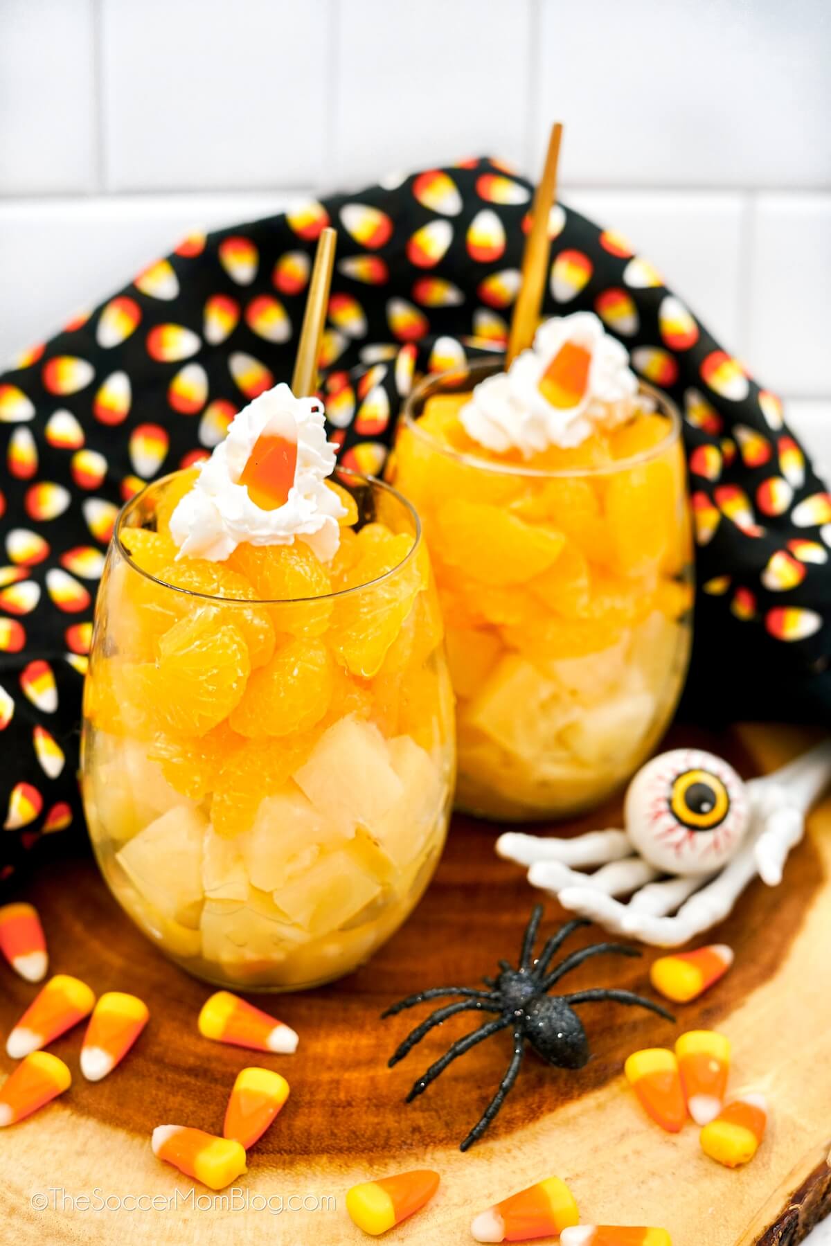 Halloween Fruit cups, layered to look like candy corn with pineapple, oranges and whipped cream