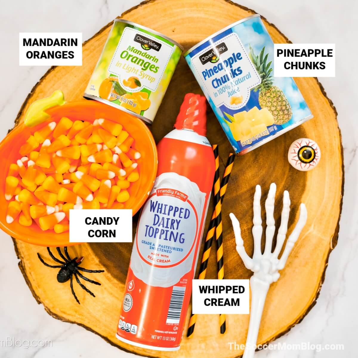 Halloween Fruit Parfait Ingredients: mandarin oranges, candy corn, pineapple chunks, and whipped cream