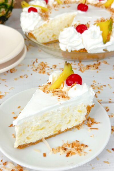 slice of pina colada cheesecake with full cake in background