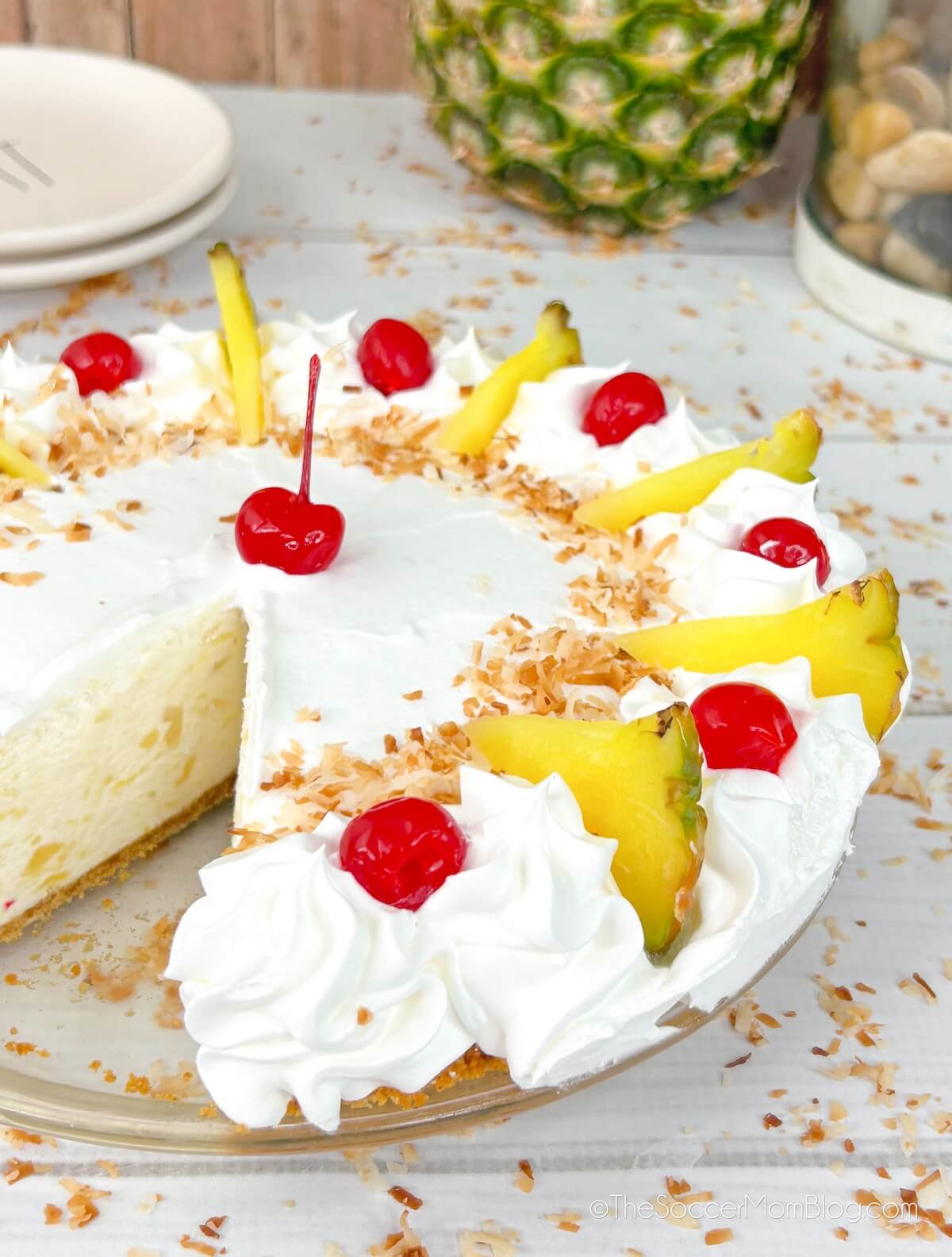 a piña colada cheesecake with a slice missing
