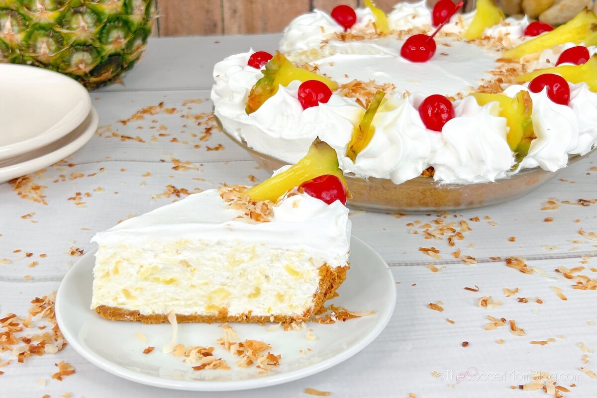 pina colada no bake cheesecake; slice on plate and full dessert in background