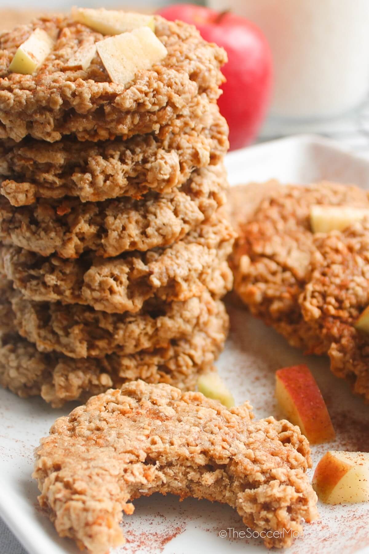 stack of apple oatmeal cookies, one in front has a bite missing