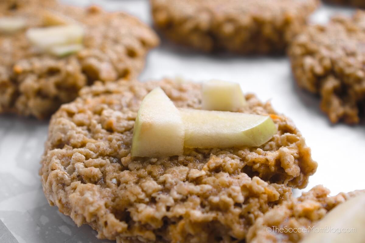 close up of an oatmeal cookie topped with apple chunks