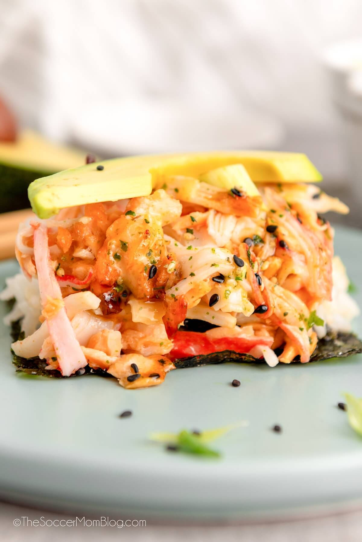 a single serving of a deconstructed sushi roll with salmon, crab, and avocado