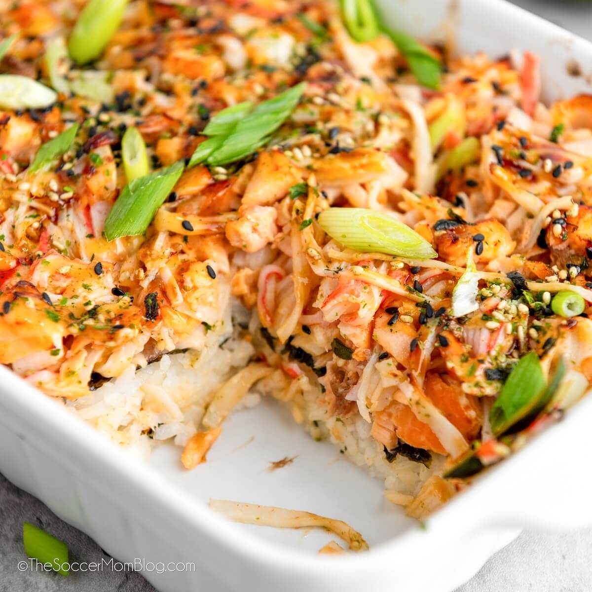 Salmon Sushi Bake, close up, to show detail of the layers of rice, salmon, and toppings