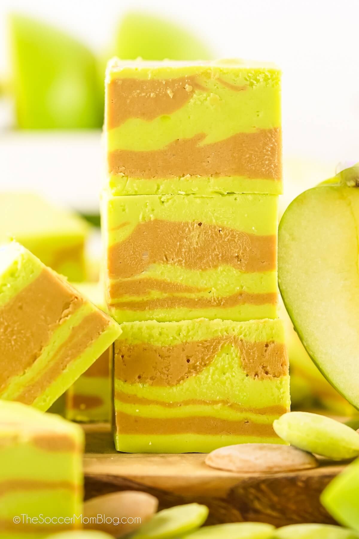 stack of 3 pieces of swirled Caramel Apple Fudge, with green apples in background