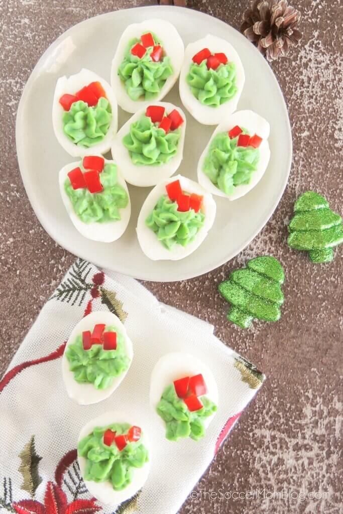 red and green Christmas Deviled Eggs on a serving plate.