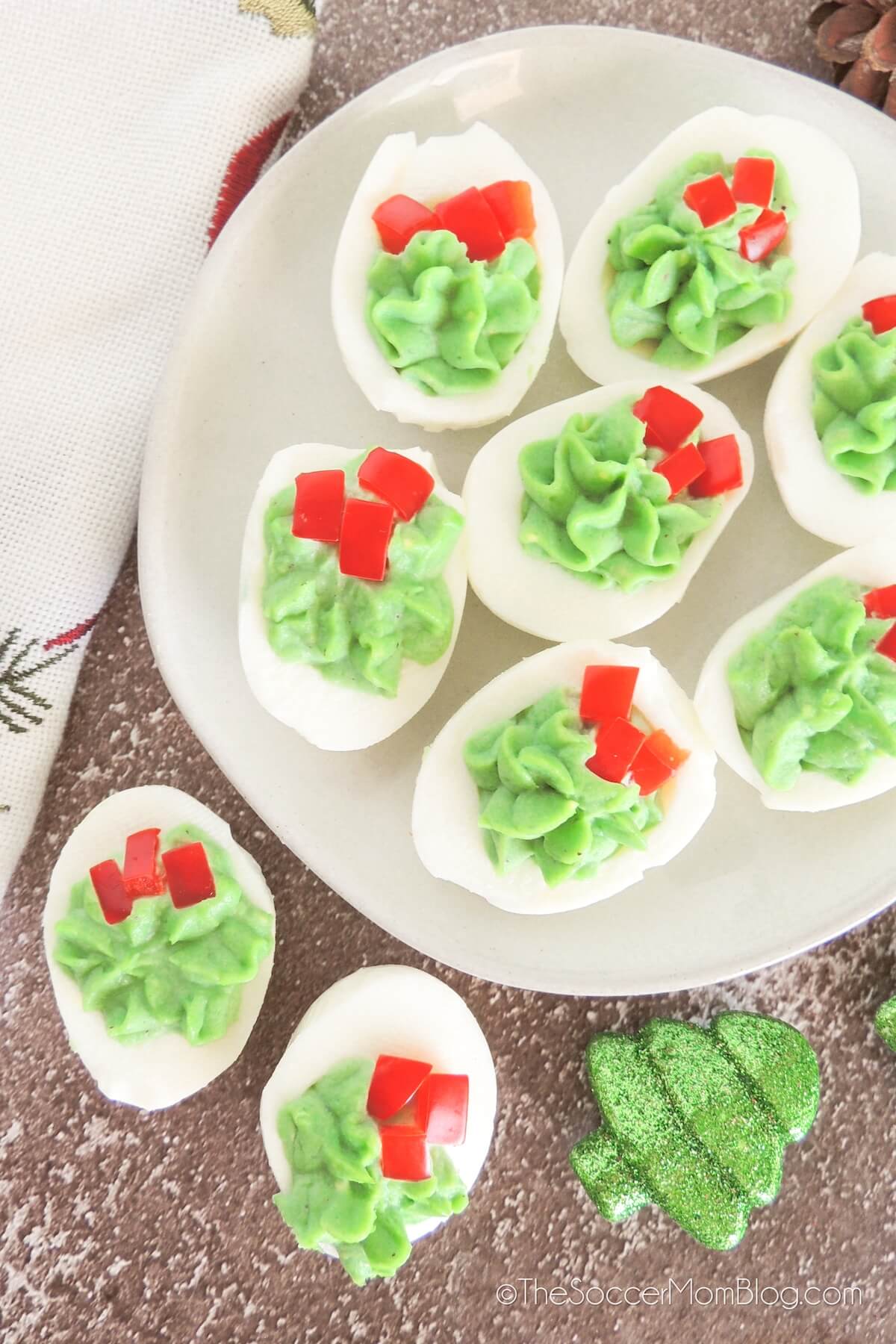 serving plate with red and green holiday deviled eggs.
