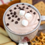 mug of hot chocolate dessert dip, topped with marshmallows and mini chocolate chips.