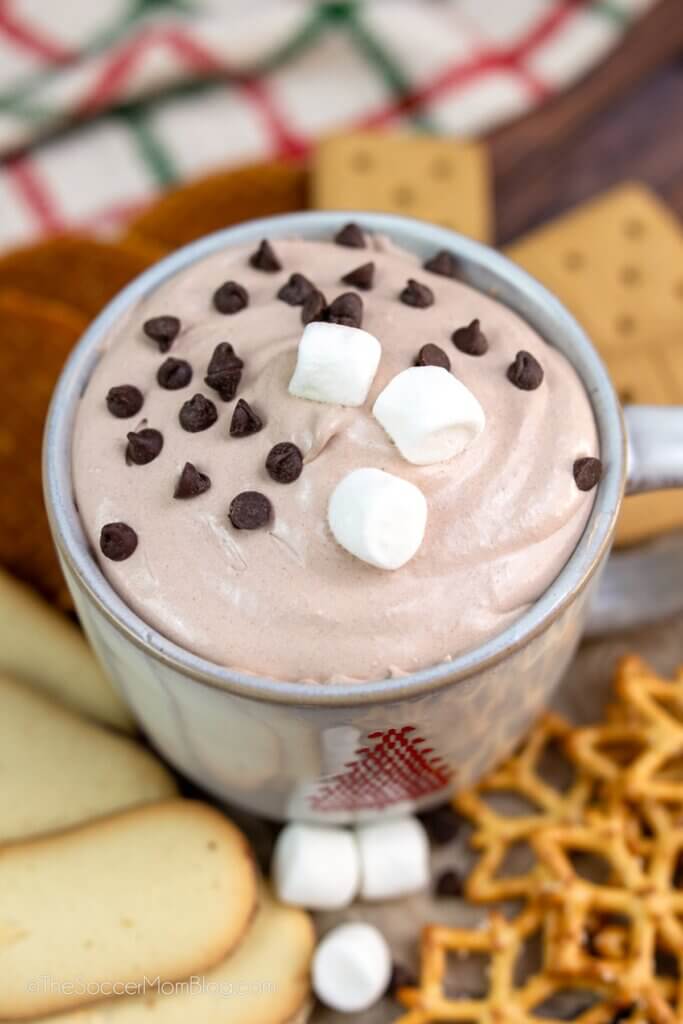 mug of hot chocolate dessert dip, topped with marshmallows and mini chocolate chips.