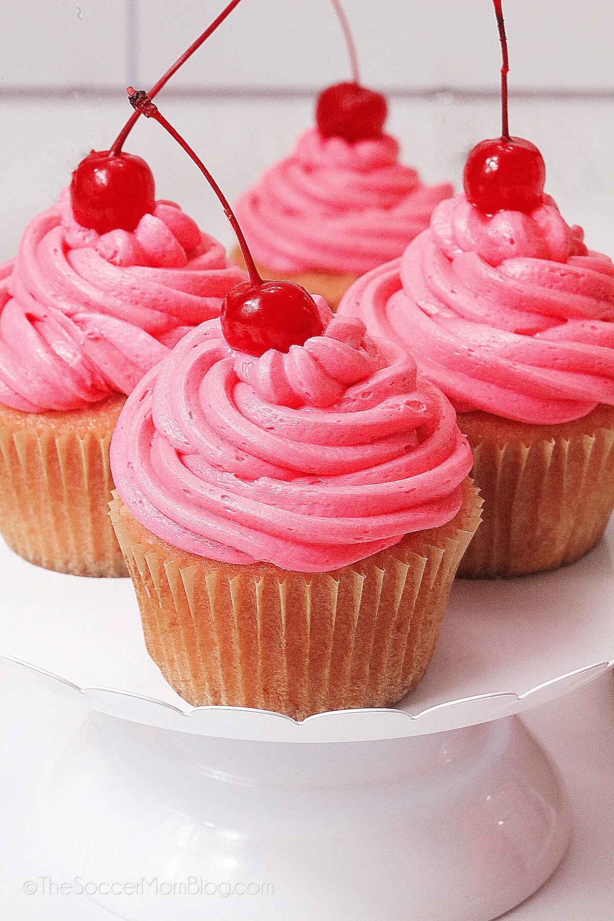 Cherry Cupcakes on a white cake stand.