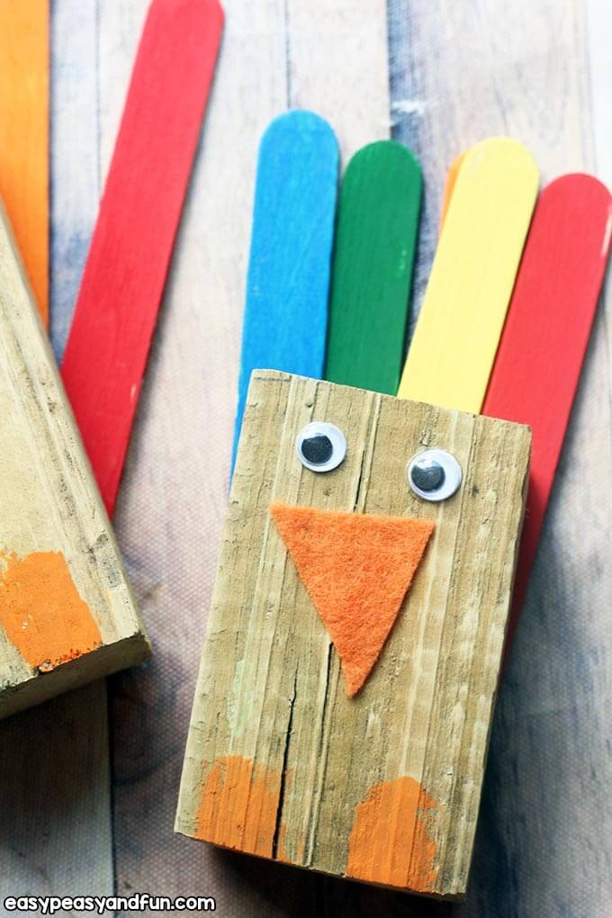 turkey craft made with wood scraps and colorful popsicle sticks.