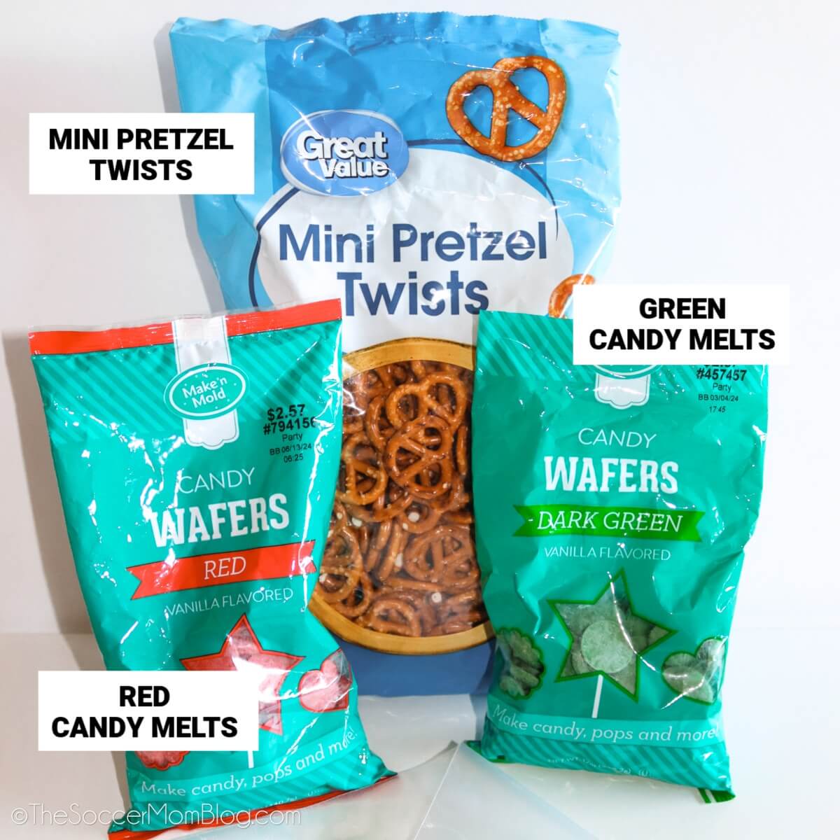 Grinch pretzel ingredients, with text labels: mini pretzel twists, green candy melts, red candy melts.