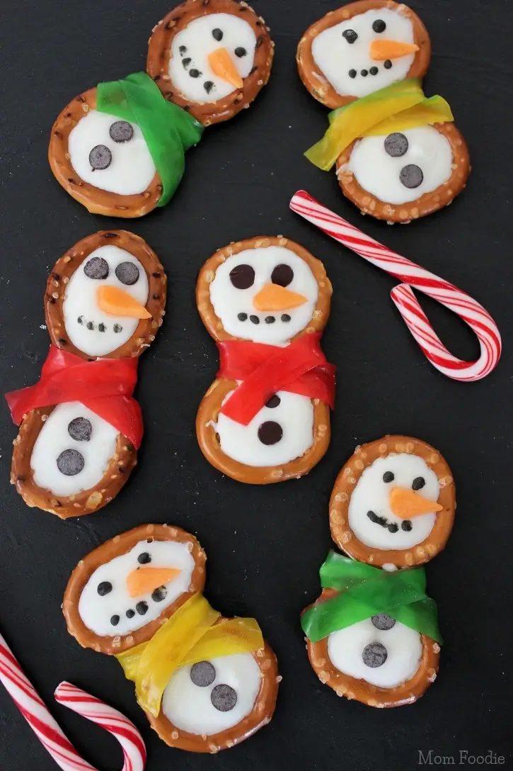 pretzel twists filled with melted white chocolate to look like snowmen.