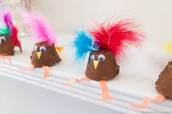 turkey craft made with painted egg cartons and colorful feathers.