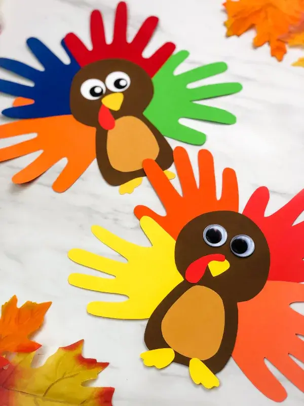 paper turkey craft made with handprint cut outs.
