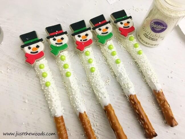 pretzel rods decorated to look like snowmen.