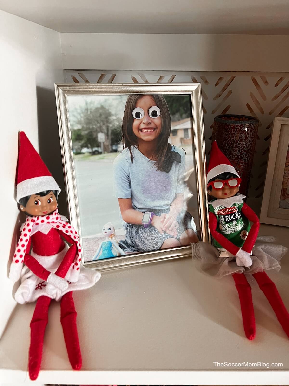 elves next to a photo of a girl with Google eyes.