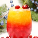 a layered Christmas drink with red and orange colors.